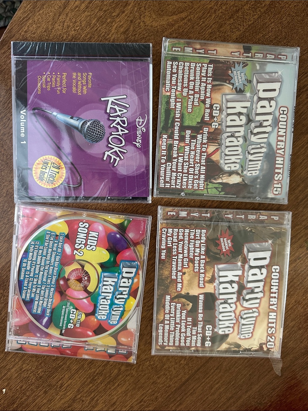 Disney & country Karaoke CDs- 3 new unopened and 1 opened and good condition